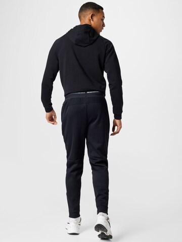 Effilé Pantalon de sport NIKE en noir