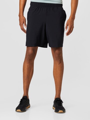 Regular Pantalon de sport UNDER ARMOUR en noir : devant