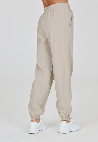 Athlecia Regular Workout Pants 'Hero' in Beige