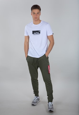 ALPHA INDUSTRIES - Tapered Calças 'X-Fit' em verde