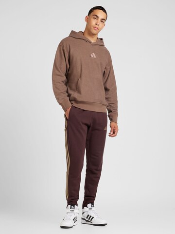 ADIDAS SPORTSWEAR - Tapered Calças de desporto 'Essentials' em castanho