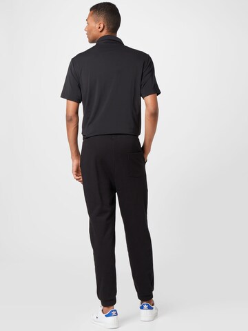 Regular Pantalon de sport 'Jano' ABOUT YOU en noir