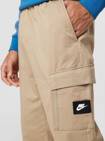 Nike Sportswear Tapered Trousers in Beige