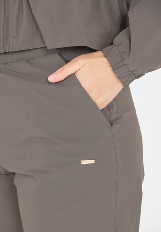 Athlecia Tapered Sporthose 'Hero' in Braun