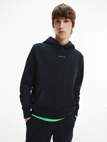 Sweat-shirt Calvin Klein Jeans en noir : devant