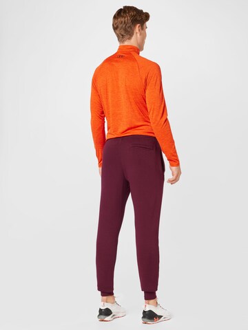UNDER ARMOUR Tapered Sports trousers 'Rival' in Red
