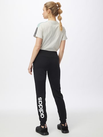 ADIDAS SPORTSWEAR Tapered Sports trousers 'Essentials Fleece Logo' in Black