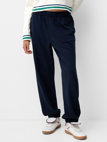 Bershka Tapered Trousers in Blue: front