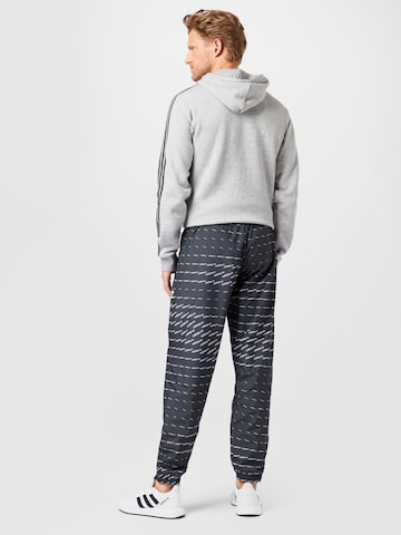 ADIDAS ORIGINALS Tapered Housut värissä musta