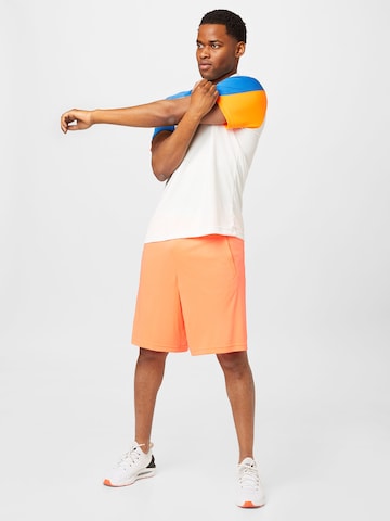 UNDER ARMOUR Ohlapna forma Športne hlače | oranžna barva