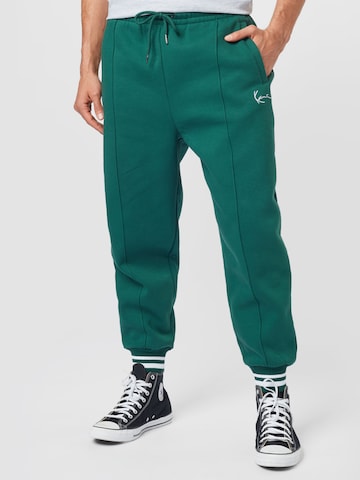 Karl Kani Tapered Pants in Green: front