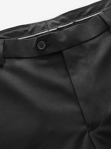 Skinny Pantaloni con piega frontale di Next in nero