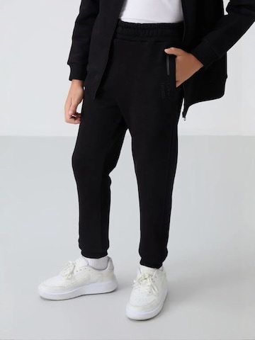 Tommy Life Trainingspak 'TOMMY Kinder Sport-Set' in Zwart