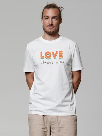 Maglietta ' Love always wins ' di Watapparel in bianco: frontale
