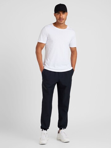 UNDER ARMOUR Tapered Sports trousers 'Unstoppable' in Black