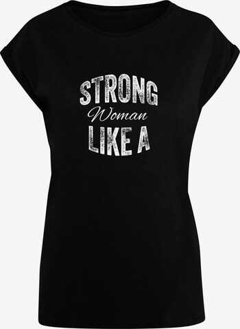 Merchcode T-Shirt 'WD - Strong Like A Woman' in Schwarz: predná strana