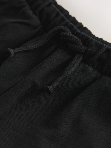 Next - Loosefit Pantalón en negro