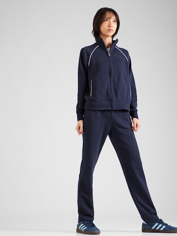 Champion Authentic Athletic Apparel Tracksuit in Blue: front