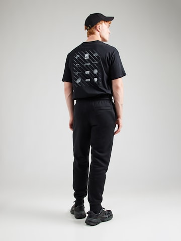 Effilé Pantalon 'CLUB' Nike Sportswear en noir