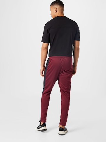 ADIDAS SPORTSWEAR - Tapered Calças de desporto 'Tiro' em vermelho