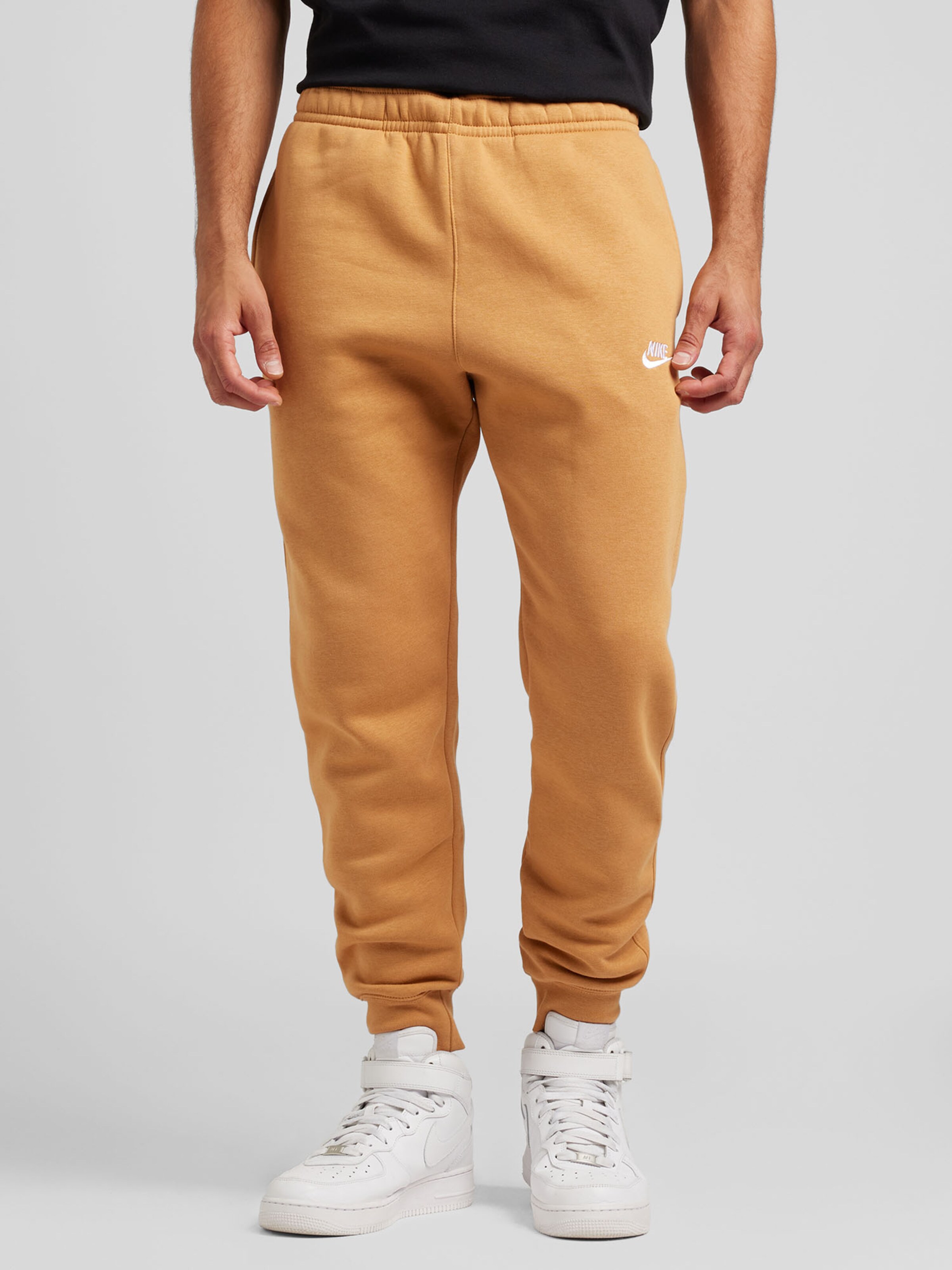 Nike Sportswear Tapered Trousers Club Fleece in Yellow ABOUT YOU
