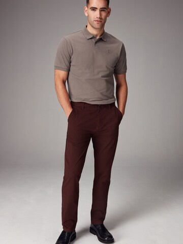 Next Slimfit Chinohousut värissä punainen