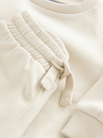 Next Juoksupuku värissä beige