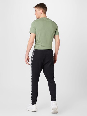 Tapered Pantaloni sportivi di Reebok in nero