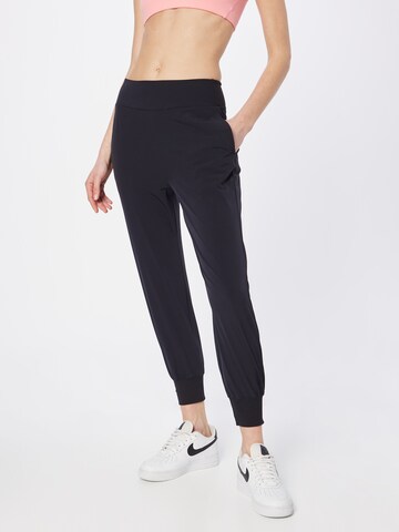 NIKE Tapered Sports trousers in Black: front