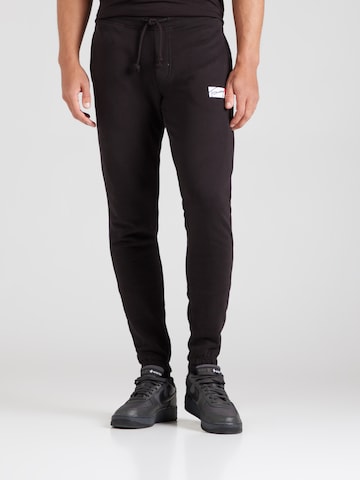 Tommy Jeans Tapered Trousers in Black: front