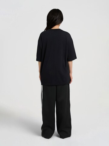 T-shirt 'Auf dem Geld' AND1 en noir