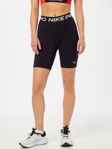 NIKE Skinny Workout Pants in Black: front