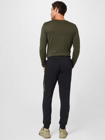 ADIDAS SPORTSWEAR Tapered Sportbroek 'Essentials Camo' in Zwart