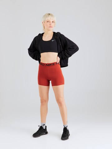 NIKE Skinny Spodnie sportowe 'Pro 365' w kolorze pomarańczowy