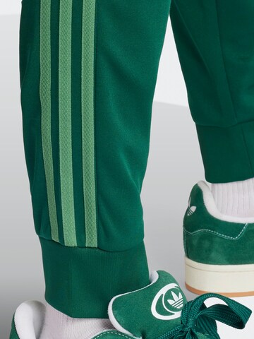 ADIDAS ORIGINALS Tapered Pants 'Adicolor Classics Sst' in Green