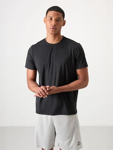 T-Shirt fonctionnel Tommy Life en noir : devant