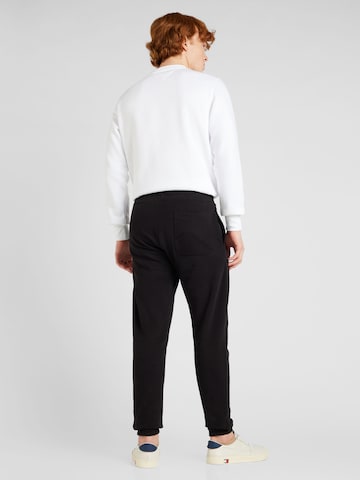 Tapered Pantaloni de la Tommy Jeans Plus pe negru