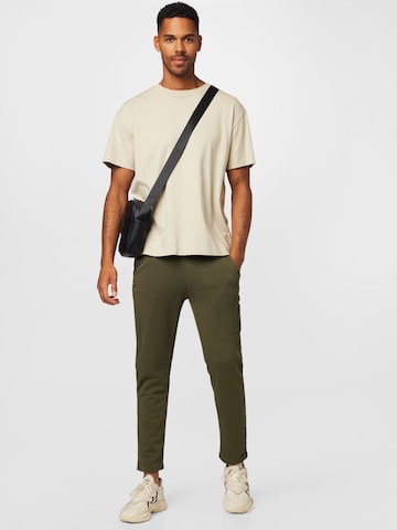 ALPHA INDUSTRIES Tapered Housut 'X-Fit' värissä vihreä