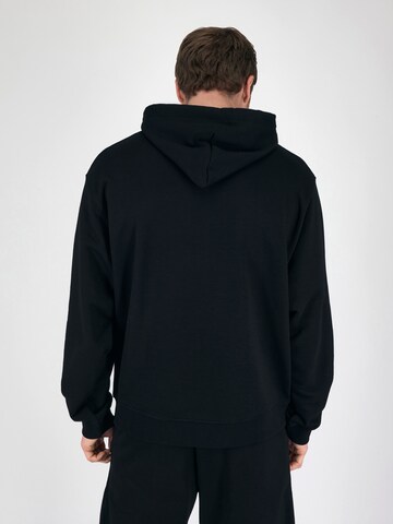 Magdeburg Los Angeles Hoodie 'ESSENTIAL* in Schwarz: zadná strana