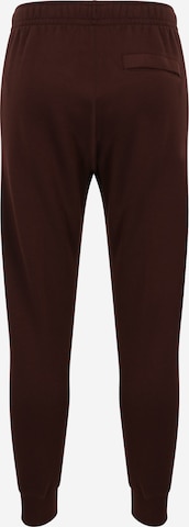 Nike Sportswear Zwężany krój Spodnie 'Club Fleece' w kolorze brązowy