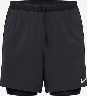 NIKE Slim fit Sports trousers in Black: front