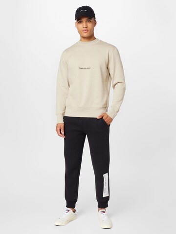 Calvin Klein Jeans Sweatshirt 'INSTITUTIONAL' in Beige