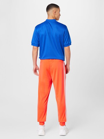 ADIDAS SPORTSWEAR Tapered Workout Pants 'Essentials Warm-Up Tapered 3-Stripes' in Red