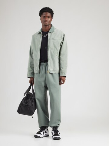 Nike Sportswear Tapered Housut 'SWSH' värissä vihreä