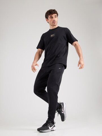 NIKE Конический (Tapered) Спортивные штаны 'Therma Sphere' в Черный