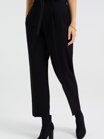 WE Fashion Tapered Pleat-Front Pants in Black: front