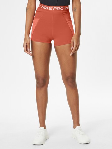 NIKE Skinny Workout Pants in Orange: front