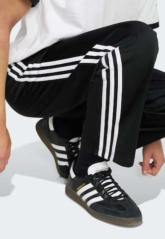Loosefit Pantalon 'Firebird' ADIDAS ORIGINALS en noir