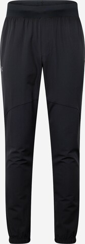 Effilé Pantalon de sport UNDER ARMOUR en noir : devant