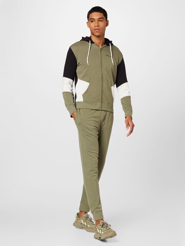 Champion Authentic Athletic Apparel Tracksuit in Green: front